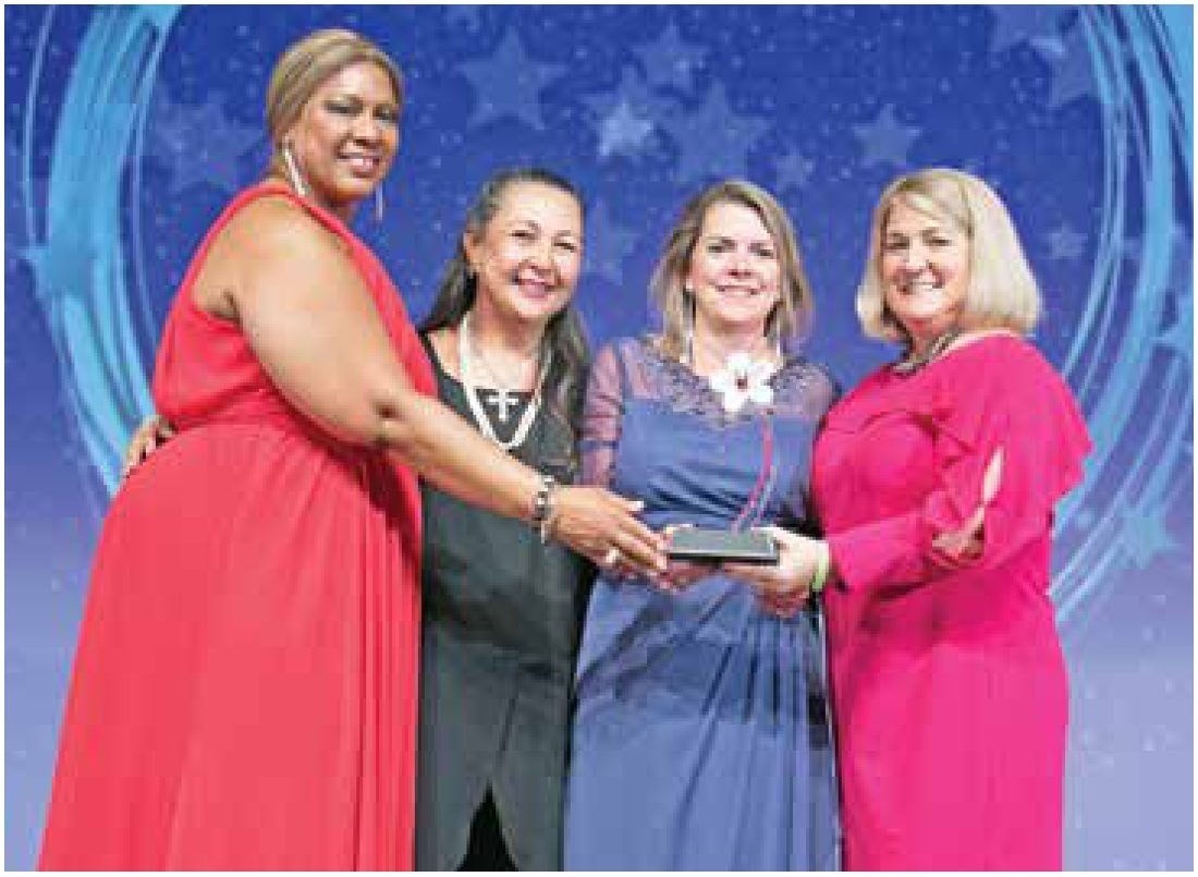 Pamela Prince-Eason presenting a WBENC award on stage.
