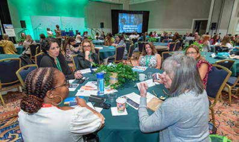 Attendees engage in roundtable discussions at the Go for the Greens annual retreat.